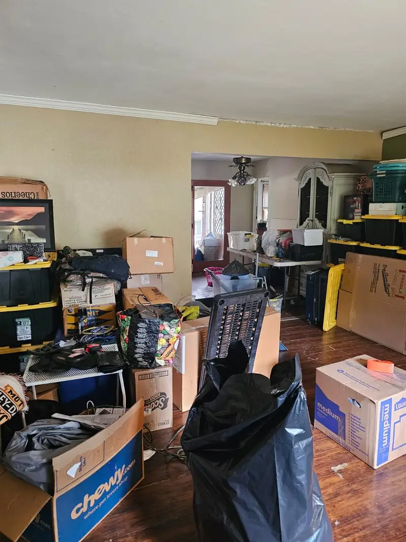 Living room packed with boxes and storage bins, Smithtown, NY